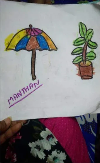 A child's drawing of an umbrella and a potted plant